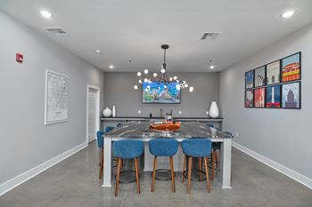a dining room with a table and chairs and a tv on the wall